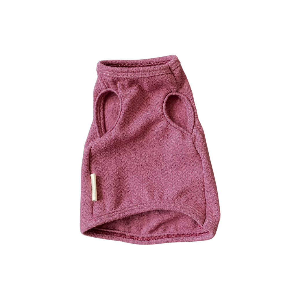 Pink dog sweater with mesh design on a white background