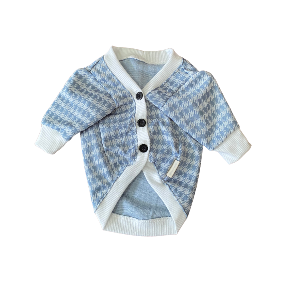 Blue and white patterned baby cardigan on a white background