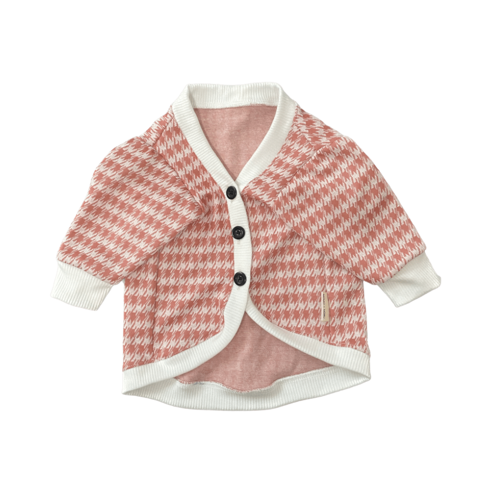 Pink and white patterned cardigan on a white background