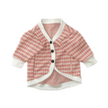 Pink and white patterned cardigan on a white background