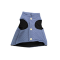 Blue quilted dog coat with black patches on a white background
