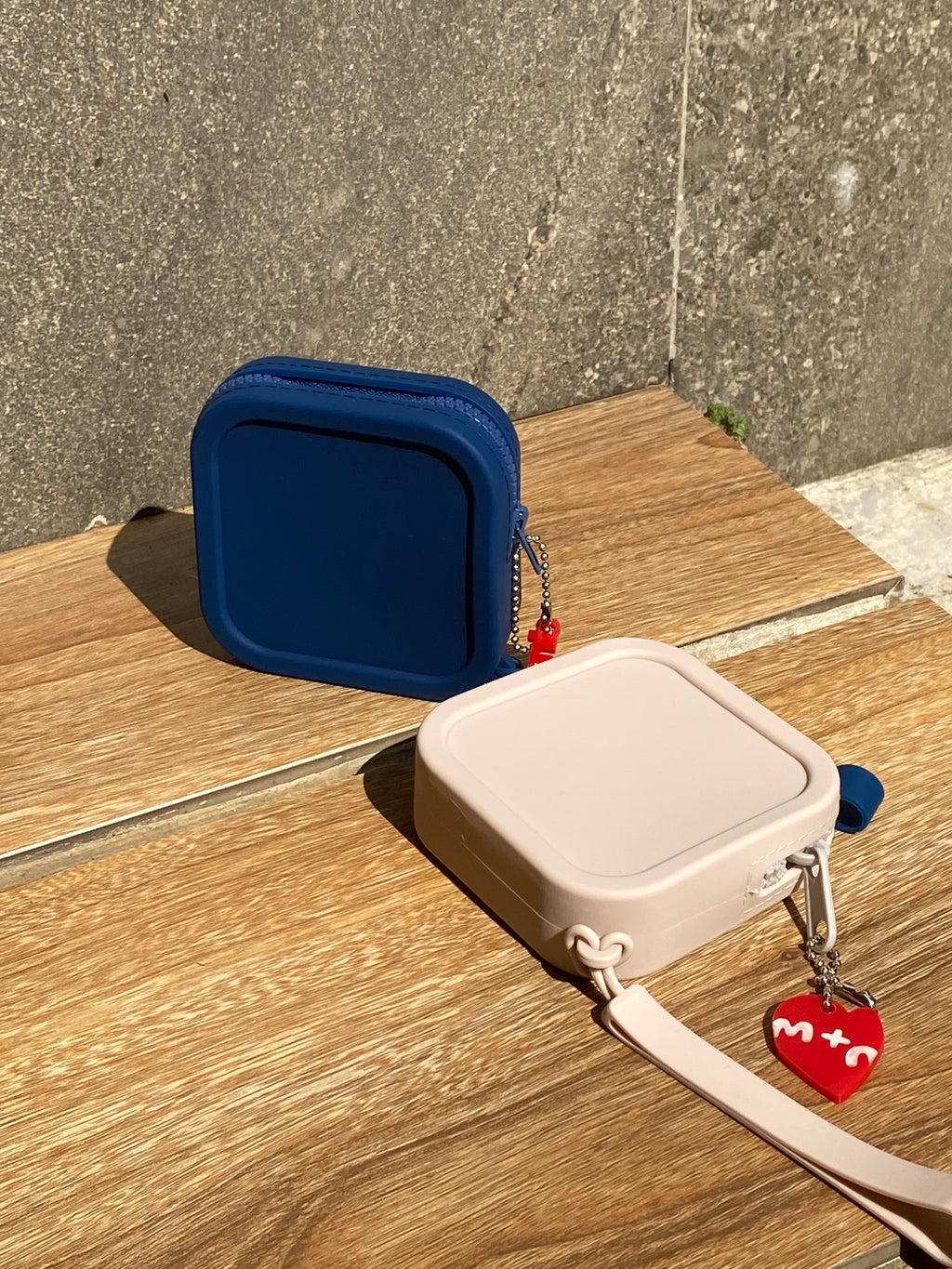 Blue and beige pouches on a wooden surface