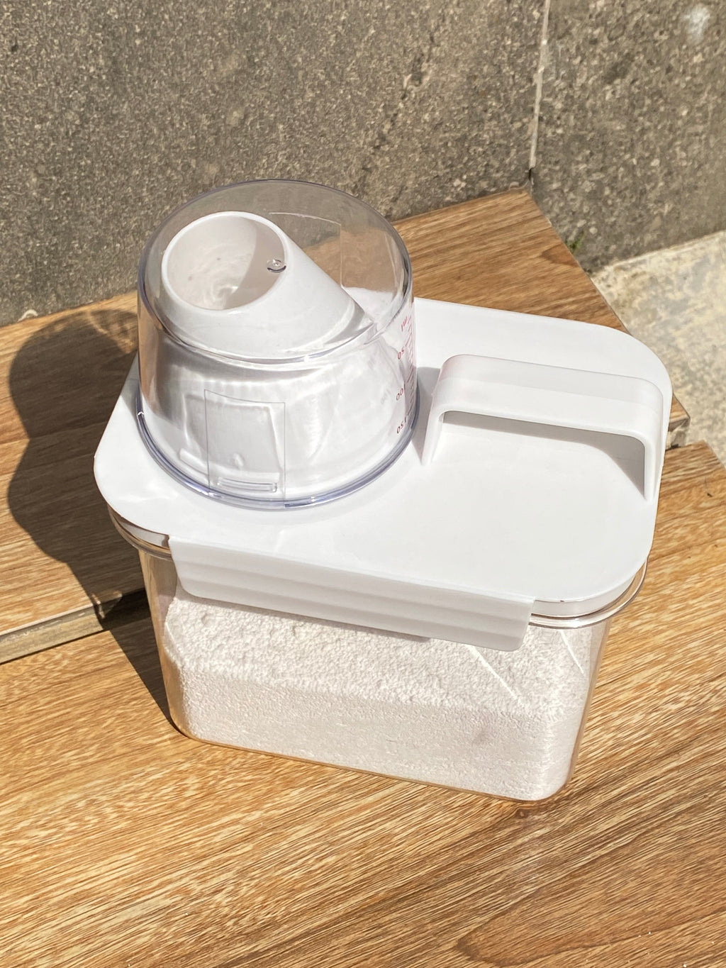 White electronic device with a clear component on a wooden surface