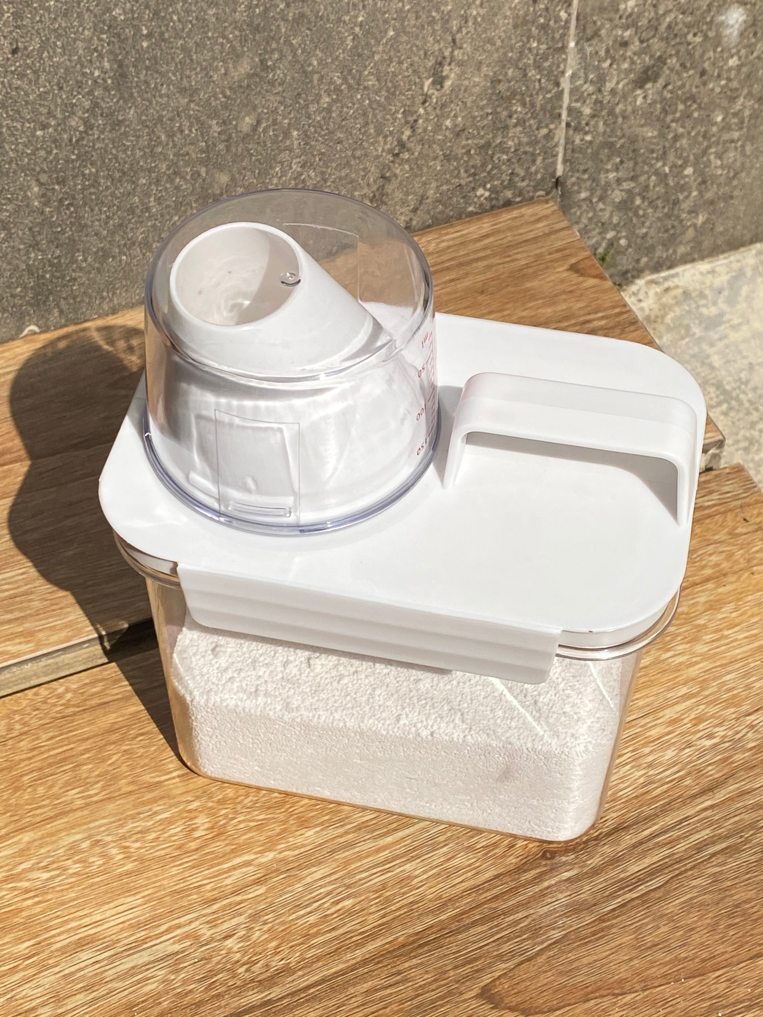 White electronic device with a clear component on a wooden surface