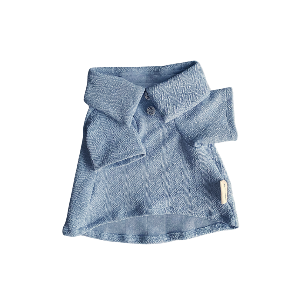 Folded blue polo shirt on a white background