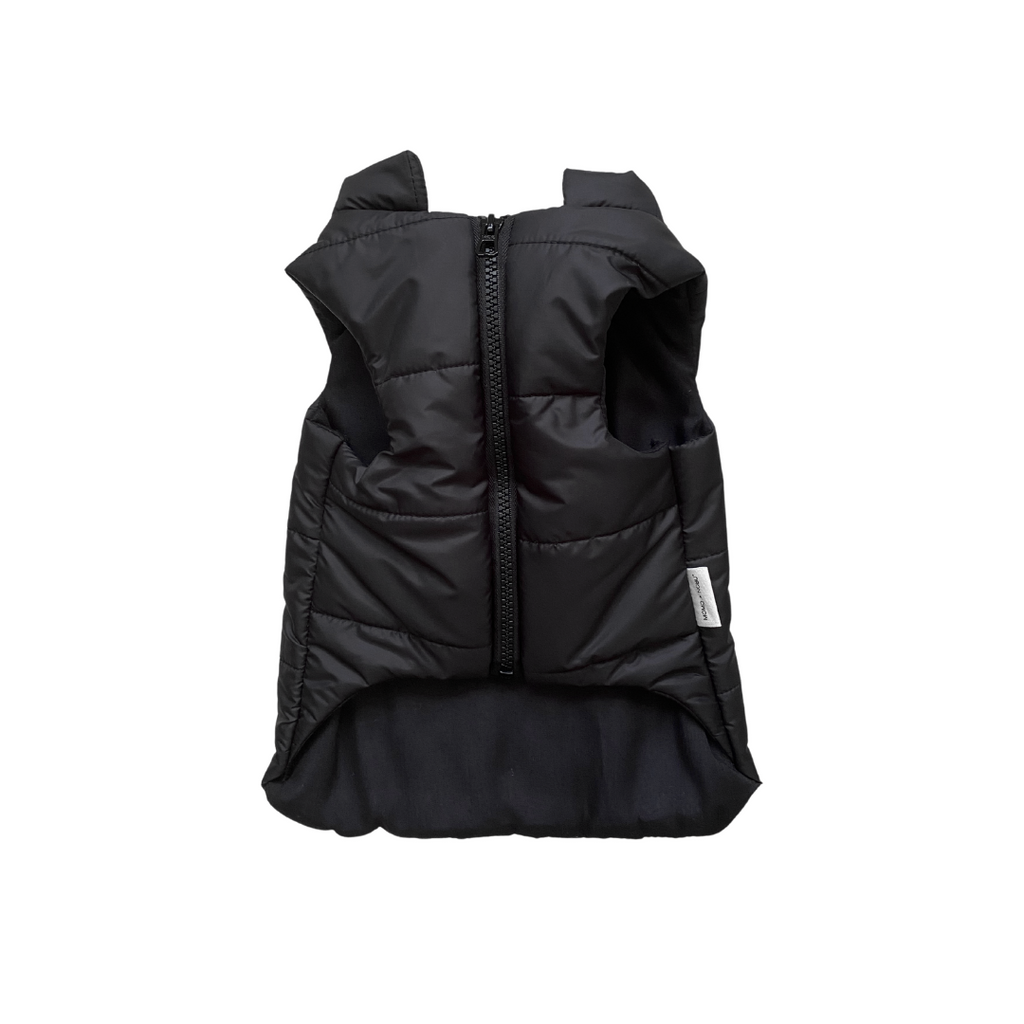 Black puffer vest on a white background