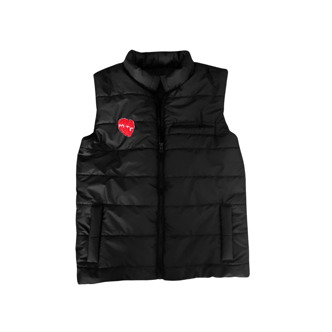 Black puffer vest with a red heart patch on a white background