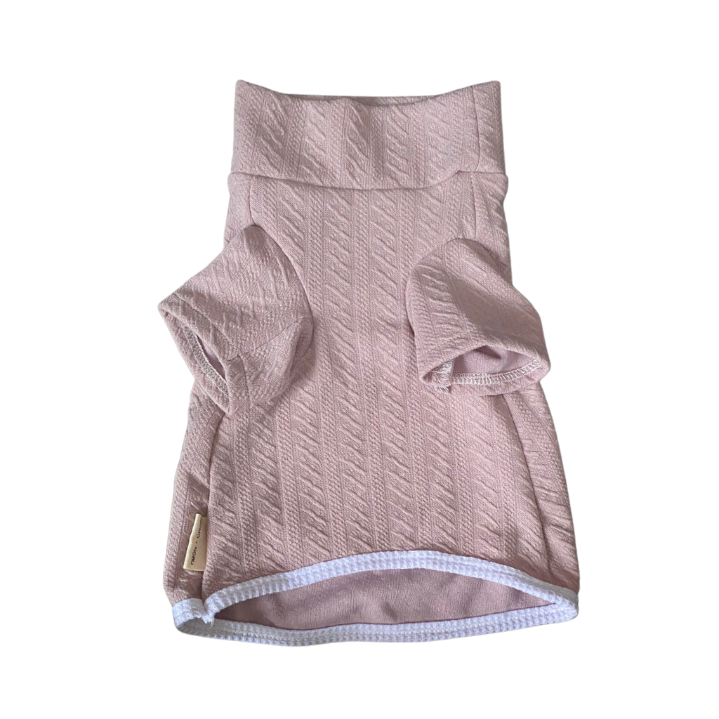 Pink textured dog sweater on a white background