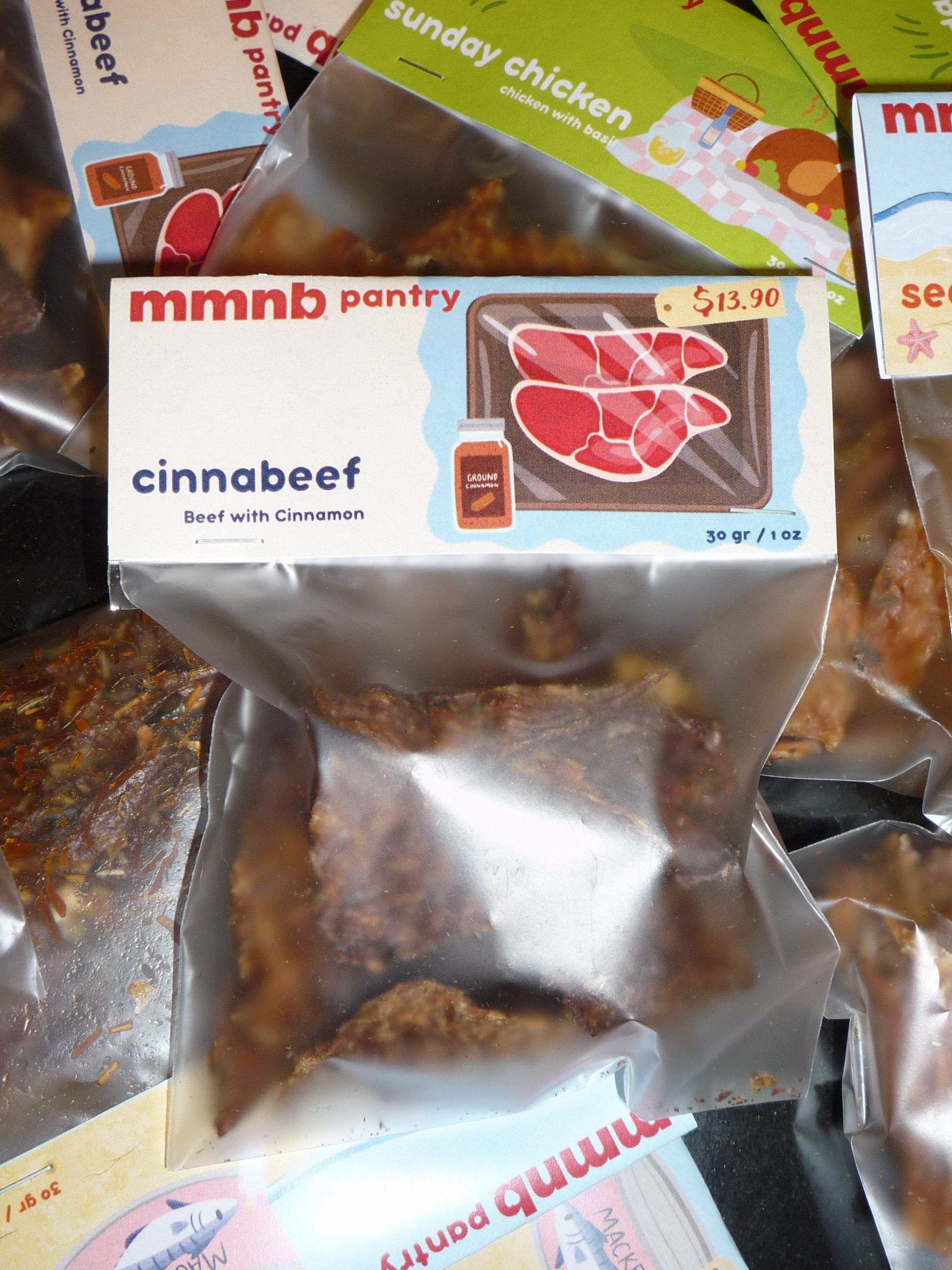 Packaged food items including a 'cinnabeef' package on a metal surface.