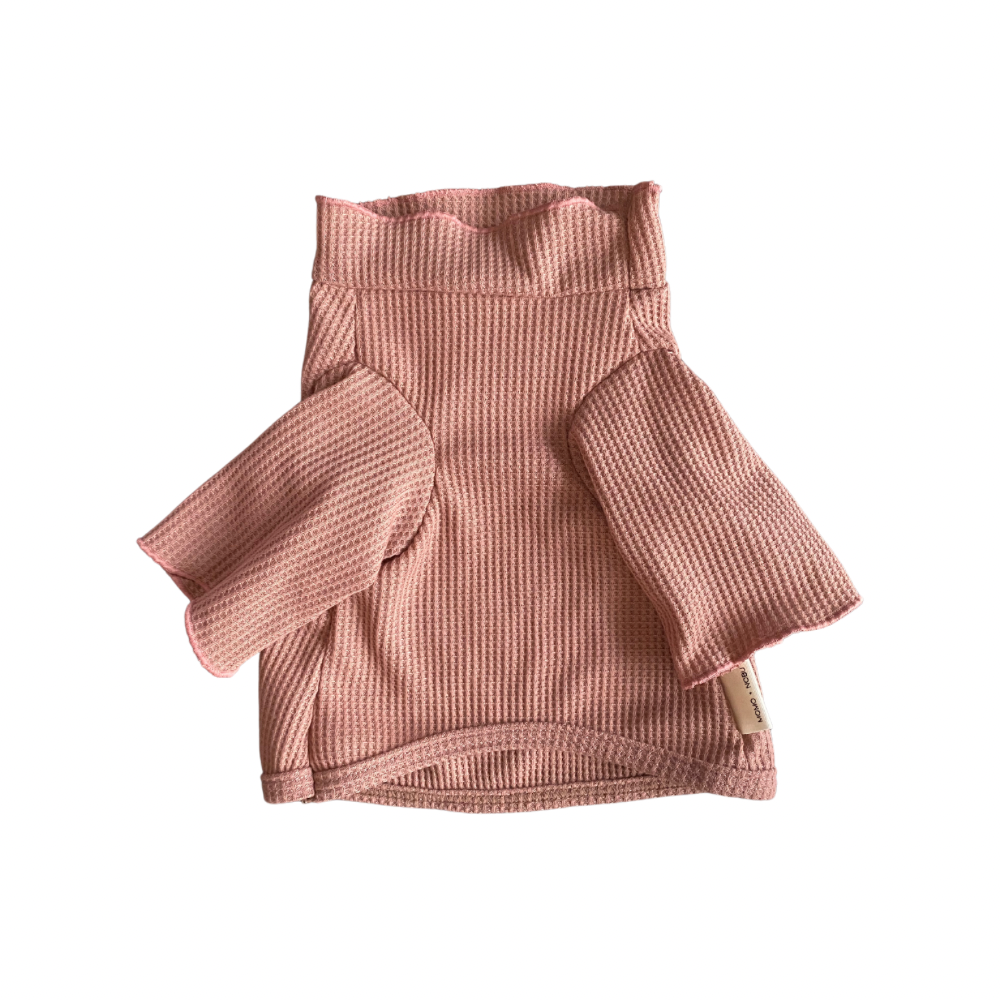 Pink textured skirt with a tag on a white background