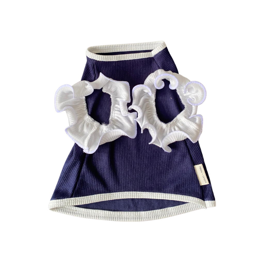 Navy blue pet dress with white ruffled details on a white background