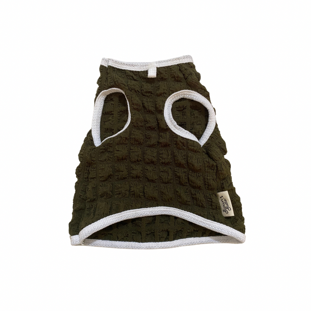 Dark green textured dog vest with white accents on a white background